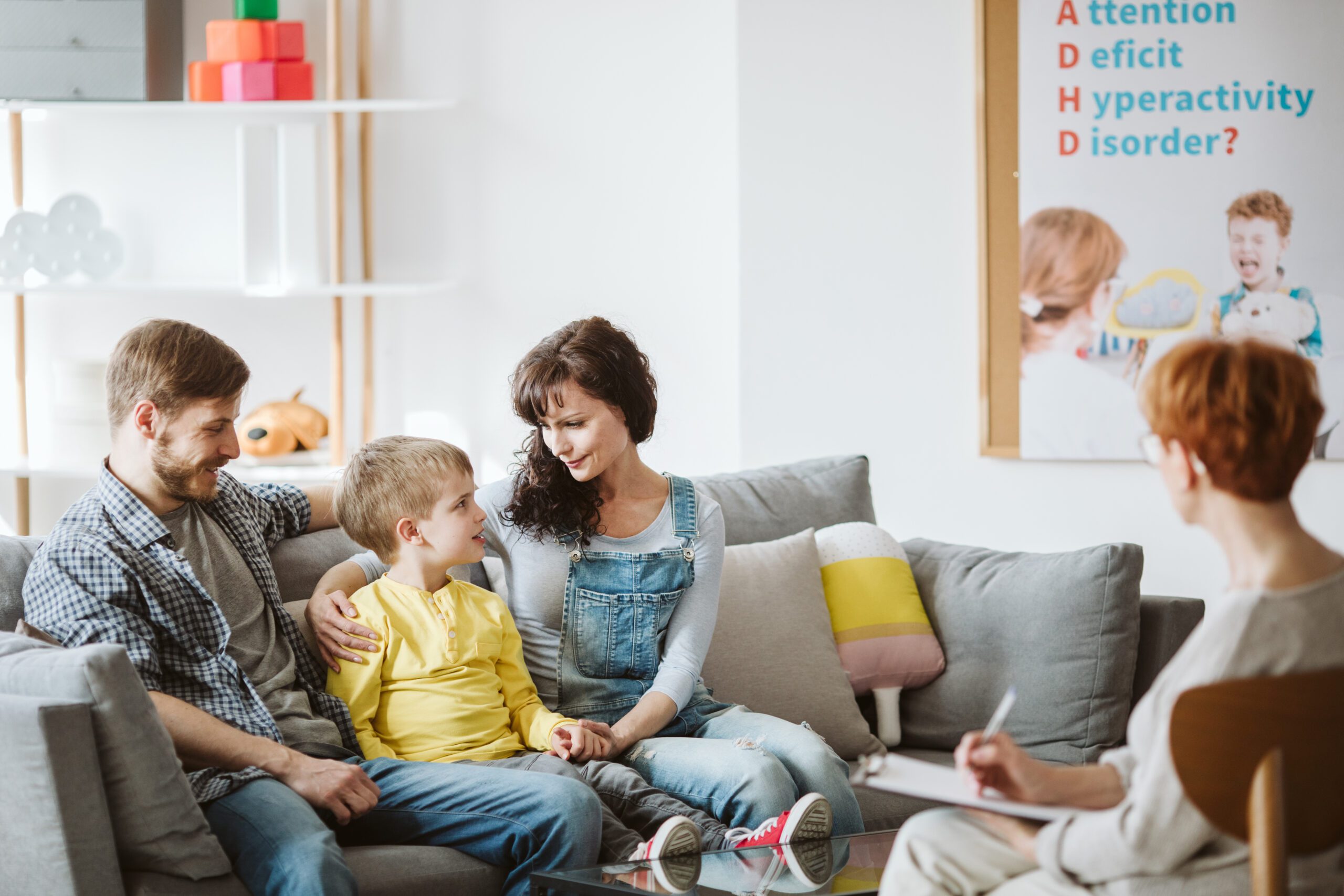 Swift Bill Caring parents and misbehaving boy during therapy session with counselor